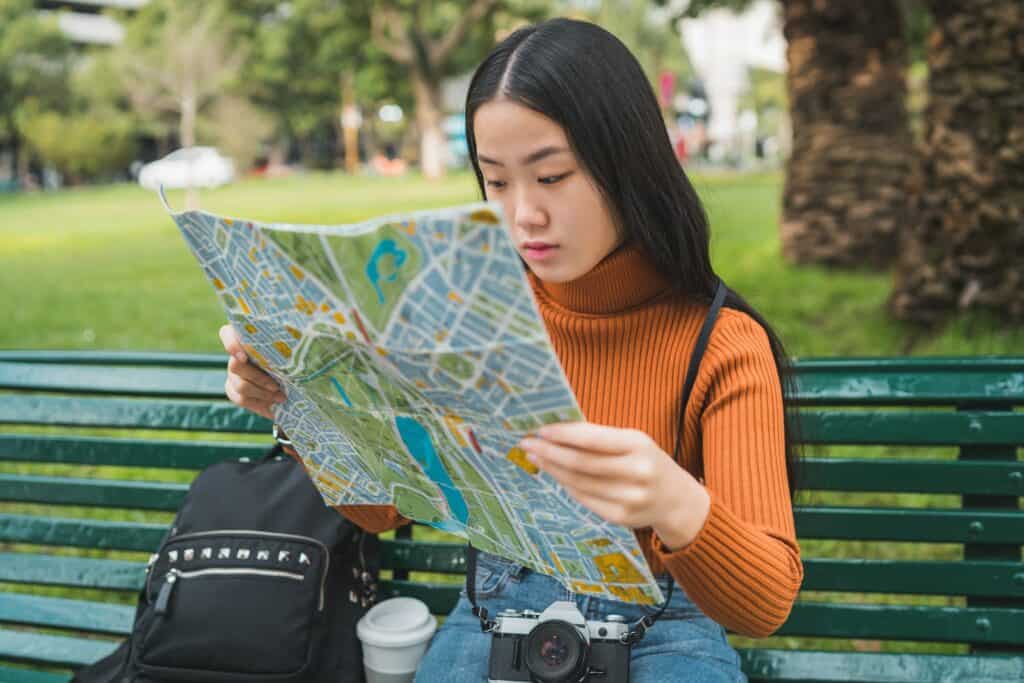 Asian woman looking at a map.