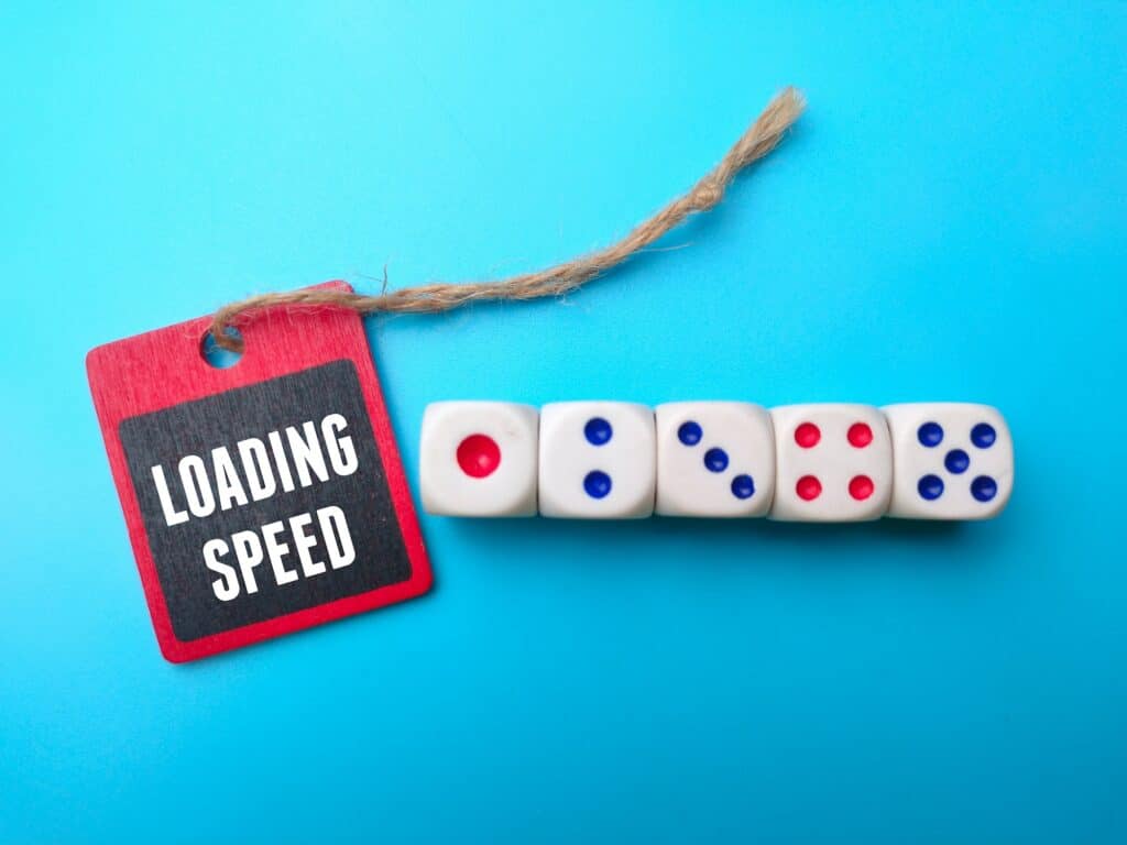 Dice and wooden board with the word LOADING SPEED.